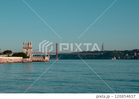 View of Tower of Belem and Ponte 25 de Abril Bridge at sunset, Lisbon, Portugal on the Tagus River 120854637