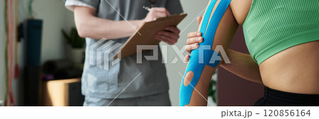 Reviewing Athletic Tape Application During Physical Therapy Session 120856164
