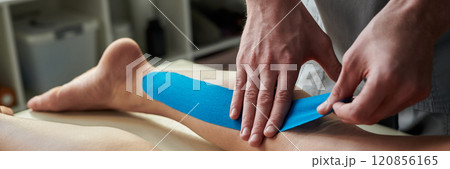 Applying Therapeutic Kinesiology Tape on Leg Applying Therapeutic Kinesiology Tape on Leg 120856165