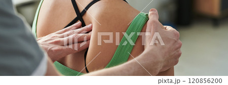 Adjusting Patient's Shoulder for Physical Therapy Session Adjusting Patient's Shoulder for Physical Therapy Session 120856200