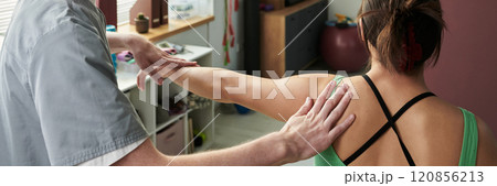 Providing Shoulder Massage in Relaxing Atmosphere Providing Shoulder Massage in Relaxing Atmosphere 120856213