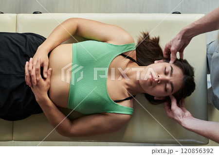 Receiving Chiropractic Adjustment During Wellness Routine 120856392