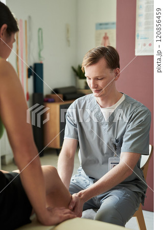 Providing Physiotherapy Treatment for Patient in Clinic Setting Providing Physiotherapy Treatment for Patient in Clinic Setting 120856459
