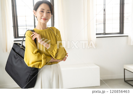 屋内でショルダーバッグを持って立つ女性 屋内でショルダーバッグを持って立つ女性 120856463