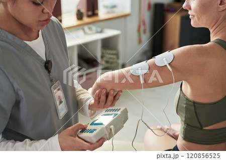Delivering Electrotherapy Treatment in Medical Facility 120856525