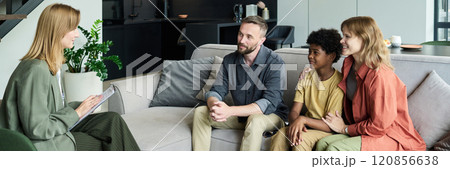 Smiling Family Sitting During Counseling Session Smiling Family Sitting During Counseling Session 120856638