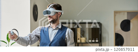 Man with VR headset and controllers 120857011