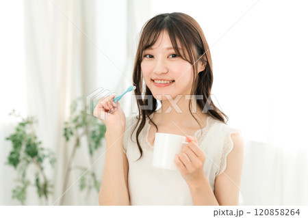家で歯磨きをする若いアジア人女性(審美歯科・ホワイトニング・デンタルケア) 120858264