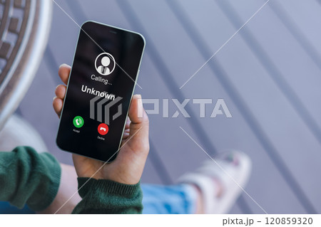 Woman receives a phone call from an unknown number, Concept of scammers or strangers, fraud, and contact to sell mobile internet promotions, spam, fake identity, scammer, scam with mobile phone. 120859320