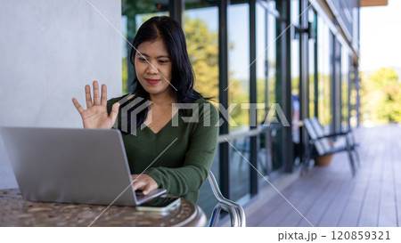 Businesswoman having video call on laptop in office online meeting tax accounting financial concepts, Woman doing meeting and accounting analysis,report,data and pointing graph at the coffee shop. Businesswoman having video call on laptop in office online meeting tax accounting financial concepts, Woman doing meeting and accounting analysis,report,data and pointing graph at the coffee shop. 120859321
