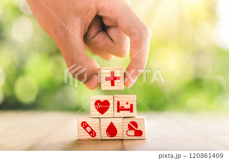 Hand arranged wooden blocks with icons of medical health. health insurance for your health concept. Healthcare medical business, medical technology equipment icon. 120861409
