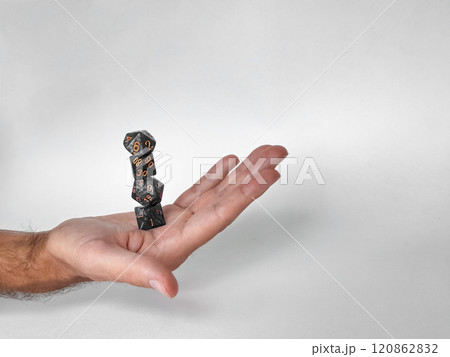 Hand balancing stacked dice: precision and skill in tabletop gaming 120862832