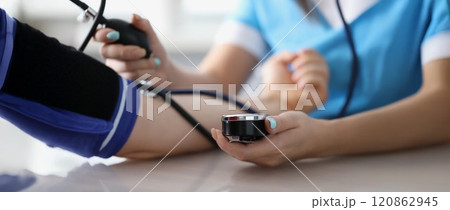 Doctor measuring patients blood pressure with tonometer tool on planned appointment Doctor measuring patients blood pressure with tonometer tool on planned appointment 120862945