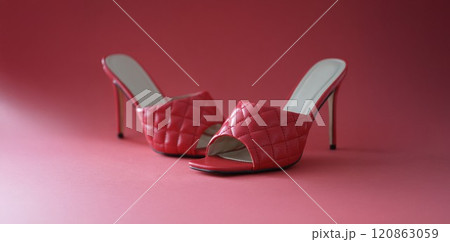 Pink slides with heels on a pink background 120863059