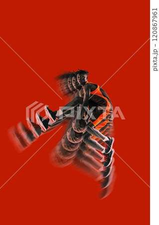 Basketball player mid-air holding ball, bold red background. Stroboscopic effect enhances dynamic phases of jump, focusing on strength and action. 120867961