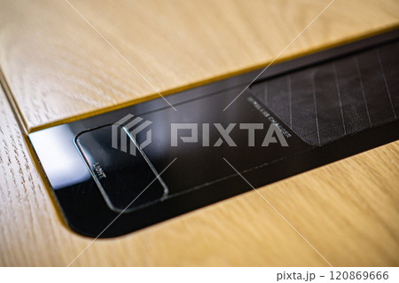 Mobile phone with wireless charger on table. Modern workplace accessory 120869666
