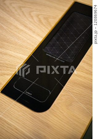 Mobile phone with wireless charger on table. Modern workplace accessory 120869674