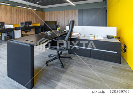 Modern office space with tables and chairs, computers and office supplies with no employees 120869763