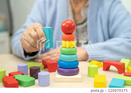 Alzheimer disease AD, Asian elderly woman patient suffering from dementia learn practical motor skills rehabilitation. 120870375