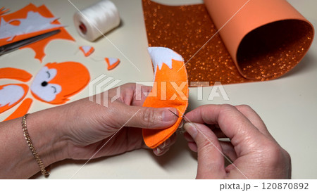 Sewing children toy from felt at home, handmade craft and art 120870892