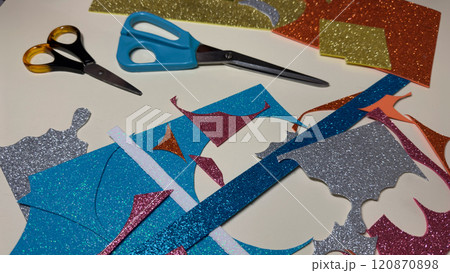 Table with cut pieces of foamiran sheets for crafts. 120870898