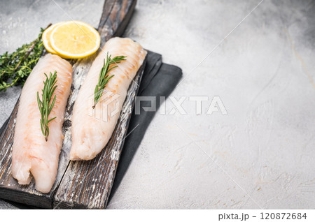 Raw cod Loin, white fish fillets without skin on wooden board. white background. top view 120872684