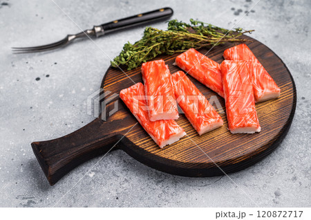 Crab sticks, crabmeat on wooden board. grey background. top view 120872717