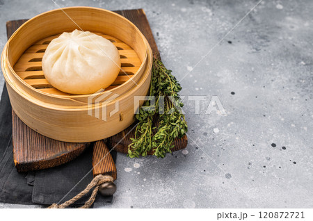 Chinese Bao or Baozi bun with meat in bamboo steamer. grey background. top view 120872721