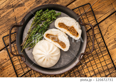 Chinese Bao Baozi steam bun with meat on steel tray. wooden background. top view Chinese Bao Baozi steam bun with meat on steel tray. wooden background. top view 120872731