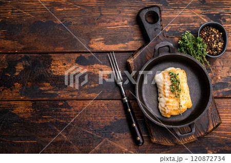 Roasted cod fish loin fiilet in skillet. Wooden background. top view 120872734