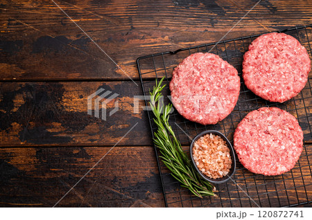 Raw meat patties, cutlets, chopped meat for burgers. wooden background. top view 120872741