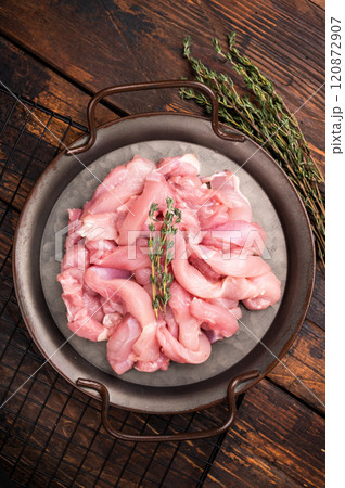 Sliced raw Chicken meat, Boneless and skinless fillets on tray. wooden background 120872907