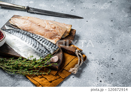 Cooking of fresh raw mackerel fillet fish on a cutting board. Gray background. Top view. Copy space 120872914