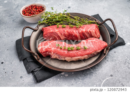 Raw Tri Tip Steak from Black Angus beef meat in stell tray. grey background. top view 120872943