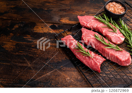 Raw Tri Tip Steak from Black Angus beef meat with rosemary. wooden background. top view Raw Tri Tip Steak from Black Angus beef meat with rosemary. wooden background. top view 120872969
