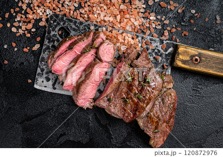 Sliced grilled Lamb fillet steak, mutton meat from leg. Black background. Top view 120872976