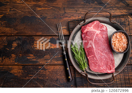 Ready for cooking Raw Rump beef steak with herbs. wooden background. top view 120872996