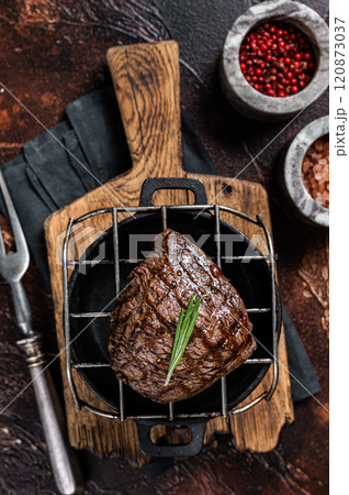Roast Rump sirloin steak with spices on a grill. Dark background. Top view 120873037