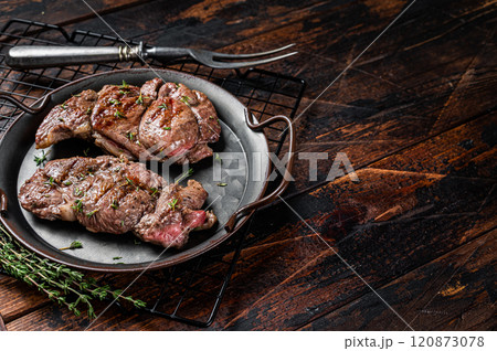 Grilled Lamb chop leg steaks, mutton meat with herbs. Wooden background. Top view. Copy space Grilled Lamb chop leg steaks, mutton meat with herbs. Wooden background. Top view. Copy space 120873078