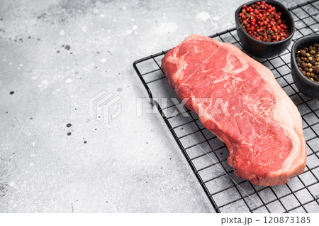Fresh Raw New York strip beef steak, strip loin with herbs. grey background. top view 120873185