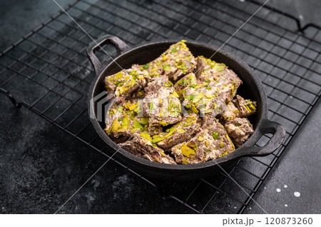 Oriental Halva with pistachio in a skillet. Natural vegan sweets. black background. top view. Oriental Halva with pistachio in a skillet. Natural vegan sweets. black background. top view. 120873260