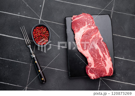 Raw Chuck eye roll steak, fresh prime beef meat. black background. top view Raw Chuck eye roll steak, fresh prime beef meat. black background. top view 120873269