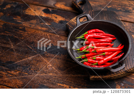 Freah Red chili peppers in a skillet isolated on white background. top view Freah Red chili peppers in a skillet isolated on white background. top view 120873301