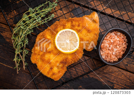 Fried Wiener chicken schnitzel steak, breaded meat. wooden background. top view 120873303