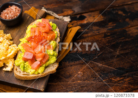 Sandwich with smoked salmon, trout, avocado and red caviar. wooden background. top view Sandwich with smoked salmon, trout, avocado and red caviar. wooden background. top view 120873378