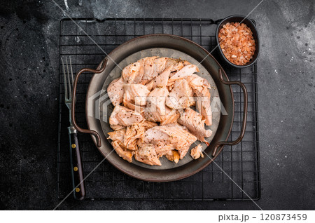 Roast salmon fillet, pulled fish meat on a steel tray. black background. Top view 120873459