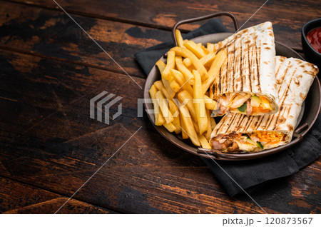 Doner kebab, Shawarma with meat, salad and french fry. wooden background. top view Doner kebab, Shawarma with meat, salad and french fry. wooden background. top view 120873567