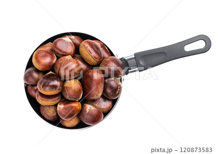 Raw chestnuts in rustic skillet ready for cooking isolated on white background Raw chestnuts in rustic skillet ready for cooking isolated on white background 120873583