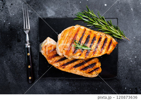 Grilled chicken breasts steaks with rosemary, farm poultry meat, top view, black background. Grilled chicken breasts steaks with rosemary, farm poultry meat, top view, black background. 120873636