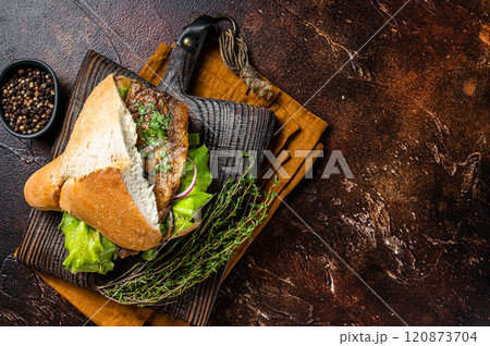 Turkish Street Food Balik Ekmek, fish sandwich with grilled mackerel fillet in a bun. Dark background. Top view. Copy space 120873704